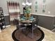 Cozy dining area featuring a round table set with turquoise dishes, complemented by wall decor and soft lighting at 4855 Mike Ln, Nashville, NC 27856