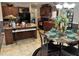 Kitchen and dining area with dark cabinetry, a kitchen island, and a table with decorative place settings at 4855 Mike Ln, Nashville, NC 27856
