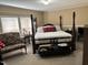 Bedroom with a king-size four poster bed, soft lighting, and comfortable seating area at 4855 Mike Ln, Nashville, NC 27856