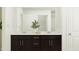 Bright bathroom features a double sink vanity with modern fixtures, and a large mirror at 521 Morning Light Dr, Angier, NC 27501
