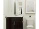 Clean bathroom with a dark wood vanity, white countertops, and a mirror, perfect for a modern home at 521 Morning Light Dr, Angier, NC 27501