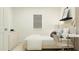 Stylish bedroom featuring a modern bed, wall art, white nightstand, and a desk with a chair at 521 Morning Light Dr, Angier, NC 27501