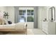 Cozy bedroom with a soft bed, large window, neutral colors, and stylish decor for a relaxing space at 521 Morning Light Dr, Angier, NC 27501