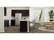 Open-concept kitchen and dining area features stainless steel appliances, a breakfast bar, and wood floors at 521 Morning Light Dr, Angier, NC 27501