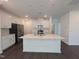 Modern kitchen with white cabinets, stainless steel appliances, quartz countertops and island with sink at 521 Morning Light Dr, Angier, NC 27501