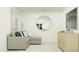 Contemporary living room with a cozy sectional sofa, a round mirror, and modern decor at 521 Morning Light Dr, Angier, NC 27501