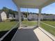 Screened-in porch offering views of the backyard and neighboring homes, perfect for outdoor living at 521 Morning Light Dr, Angier, NC 27501