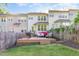 The home boasts a well-maintained yard with a deck and a charming, shaded area, ideal for outdoor gatherings at 521 Village Loop Dr, Apex, NC 27502