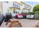 Relaxing backyard deck with cushioned seating, grill, and a wooden picnic table at 521 Village Loop Dr, Apex, NC 27502
