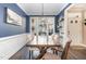 Bright dining room featuring a long wooden table with seating for eight and modern light fixture at 521 Village Loop Dr, Apex, NC 27502