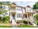 Desirable townhome exterior with lovely landscaping, second story balcony and welcoming entrance at 521 Village Loop Dr, Apex, NC 27502