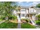 Well-maintained townhome with manicured lawn, charming entryway, and second story balcony at 521 Village Loop Dr, Apex, NC 27502