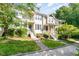 Attractive townhome exteriors with well-kept lawns, and inviting front entrances at 521 Village Loop Dr, Apex, NC 27502