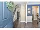 Inviting foyer with hardwood floors, staircase, and decoratively painted accent wall at 521 Village Loop Dr, Apex, NC 27502