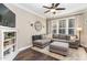 Comfortable living room with large sectional couch, decorative lighting, and large picture window at 521 Village Loop Dr, Apex, NC 27502