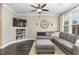Bright living room with a large sectional sofa, and built in shelving at 521 Village Loop Dr, Apex, NC 27502