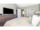 Main bedroom features an ensuite bathroom, walk-in closet, a large television and photo gallery wall at 521 Village Loop Dr, Apex, NC 27502