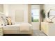 Bright bedroom features large windows, neutral decor, dresser, and comfortable bed at 529 Morning Light Dr, Angier, NC 27501