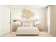 Bright bedroom with natural decor, stylish nightstands, lamps, and a comfortable bed at 529 Morning Light Dr, Angier, NC 27501