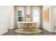 Inviting dining area featuring a round table with seating for six, complemented by stylish artwork and natural light at 529 Morning Light Dr, Angier, NC 27501