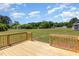 Spacious backyard view from the wooden deck reveals a lush lawn, mature trees, and serene outdoor setting at 5337 Nc Hwy 96, Selma, NC 27576