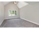 Spacious bedroom showcasing vaulted ceilings, a ceiling fan, and a large window at 5337 Nc Hwy 96, Selma, NC 27576