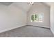 Primary bedroom with vaulted ceiling, gray carpet, and a triple window at 5337 Nc Hwy 96, Selma, NC 27576