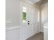 Bright entryway with white trim, neutral walls and carpet, and sidelight windows around the front door at 5337 Nc Hwy 96, Selma, NC 27576