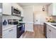 Well-lit kitchen featuring stainless steel appliances, white cabinetry, and light countertops at 5337 Nc Hwy 96, Selma, NC 27576