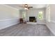Spacious living room features a painted brick fireplace, neutral walls, carpet and trim at 5337 Nc Hwy 96, Selma, NC 27576