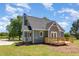 Exterior rear view showcases a charming home with a wooden deck, gray siding, and a well-maintained yard at 5337 Nc Hwy 96, Selma, NC 27576