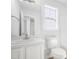 This bathroom includes a window, toilet, mirror, and sink at 5456 Grand Traverse Dr, Raleigh, NC 27604