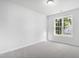 A bright bedroom with neutral walls and carpet with a window view at 5456 Grand Traverse Dr, Raleigh, NC 27604