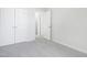 This bedroom shows two closet doors, neutral walls and carpet at 5456 Grand Traverse Dr, Raleigh, NC 27604