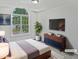 Staged bedroom boasts a large arched window, TV, and modern dresser at 5456 Grand Traverse Dr, Raleigh, NC 27604