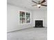 Open-concept living room showcasing a fireplace and ample natural light through a large window at 5456 Grand Traverse Dr, Raleigh, NC 27604