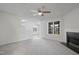 Bright living room features plush carpet, a ceiling fan, and a cozy fireplace at 5456 Grand Traverse Dr, Raleigh, NC 27604