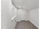 Finished basement featuring white brick walls, tile flooring, and a freshly painted white door at 620 Wexford Dr, Raleigh, NC 27603