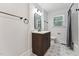Bathroom featuring modern vanity, updated fixtures, and decorative starburst patterned tile flooring at 620 Wexford Dr, Raleigh, NC 27603