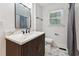 Bathroom featuring modern vanity, updated fixtures, and decorative starburst patterned tile flooring at 620 Wexford Dr, Raleigh, NC 27603