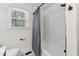 Updated bathtub and shower combination featuring a white subway tile backsplash and modern fixtures at 620 Wexford Dr, Raleigh, NC 27603