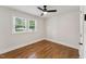 Bedroom featuring hardwood floors, fresh white paint, a ceiling fan, and natural light from the window at 620 Wexford Dr, Raleigh, NC 27603