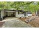 Charming single-story home with a covered parking area, well-maintained landscaping, and a stone walkway at 620 Wexford Dr, Raleigh, NC 27603
