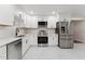 Newly renovated kitchen featuring modern stainless steel appliances, white cabinets, and marble countertops at 620 Wexford Dr, Raleigh, NC 27603
