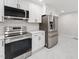Renovated kitchen area showcasing new appliances, white cabinets, and an open design leading to the next space at 620 Wexford Dr, Raleigh, NC 27603