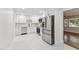 Modern, open kitchen featuring sleek stainless steel appliances and stylish white cabinets with plenty of counter space at 620 Wexford Dr, Raleigh, NC 27603