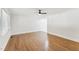 Empty Living Room shows a ceiling fan, hardwood floors and a door with three windows to the right of it at 620 Wexford Dr, Raleigh, NC 27603