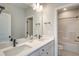 Bathroom with a double sink vanity, large mirror, and shower/tub combo at 63 W Victoria Ridge Dr # 31, Selma, NC 27576