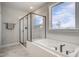 Modern bathroom showcasing a soaking tub and a glass-enclosed shower with sleek fixtures at 63 W Victoria Ridge Dr # 31, Selma, NC 27576