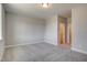 A light filled bedroom showing a walk-in closet and a bathroom. The room is empty and carpeted at 63 W Victoria Ridge Dr # 31, Selma, NC 27576